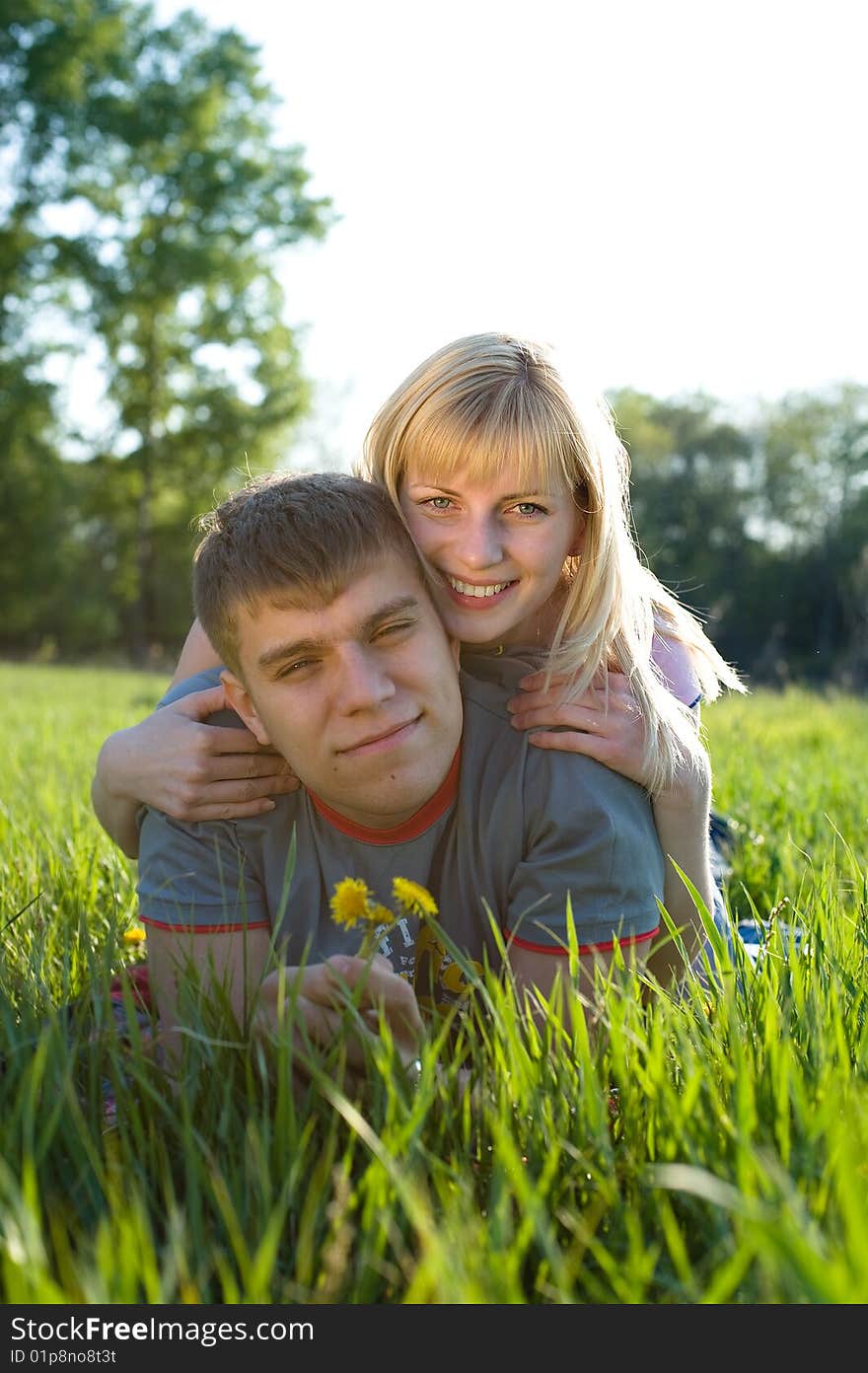 Happiness couple in love on green grass. Happiness couple in love on green grass