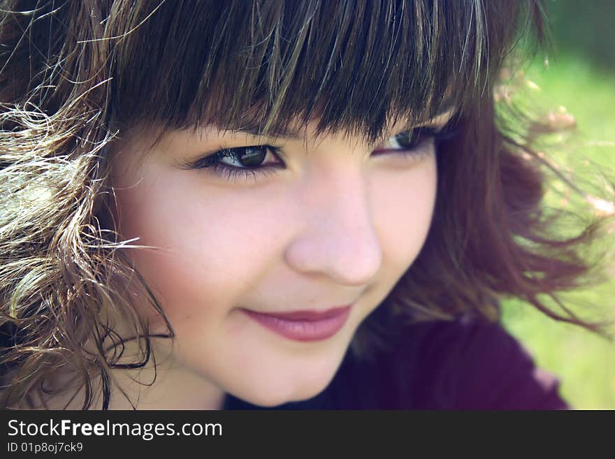 Smiling  sly girl and green grass