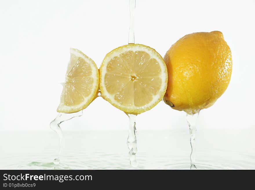 Lemon juice splashing on lemons