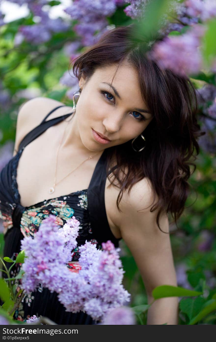 Tender girl in the garden with lilac