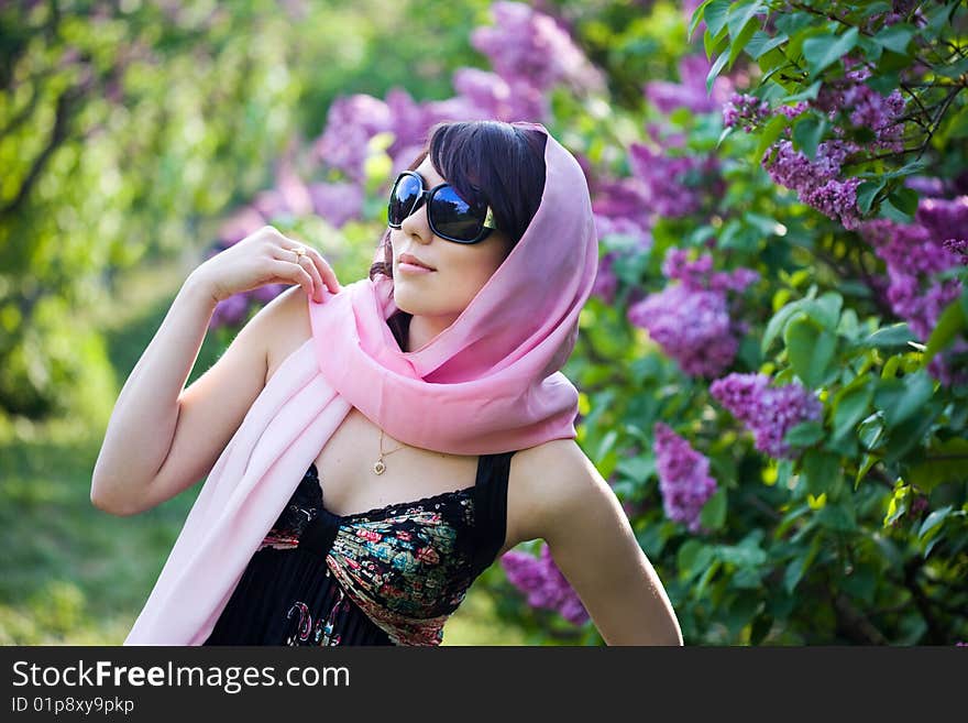 Tender girl in the garden with lilac