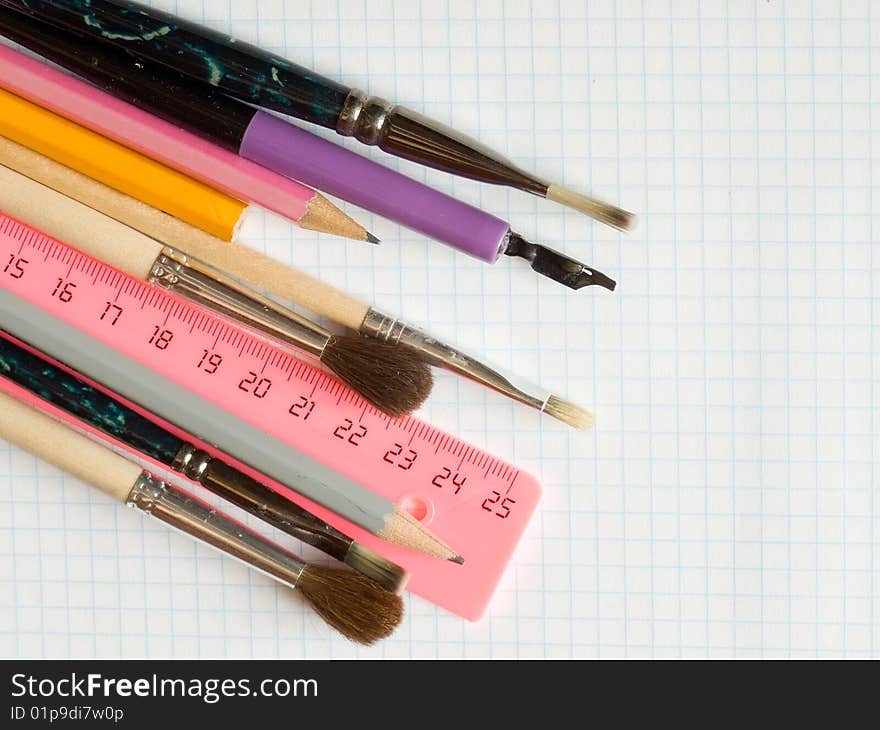 School supplies  on squared sheet of a copybook