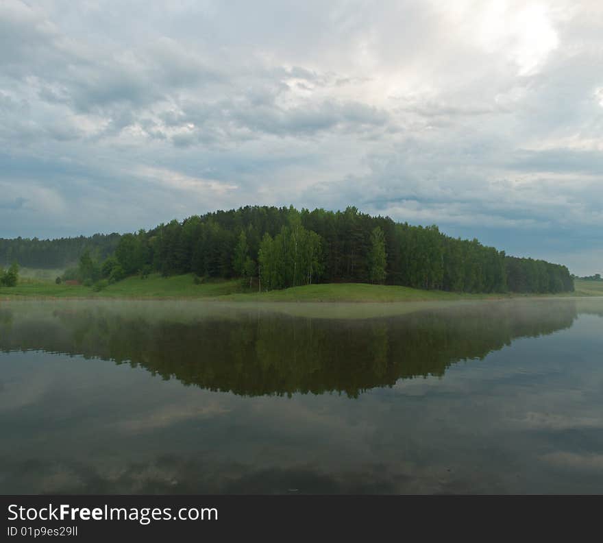 Early morning, view of the lake after the rain. Beautiful reflection of the forest in the water.
Russian Nature, Spring 2009.