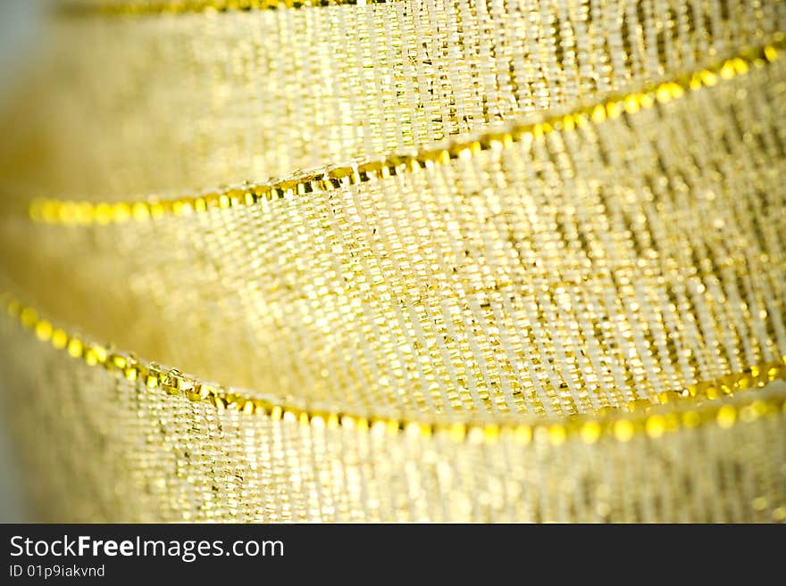 Ribbon in gold color, close up shot with selective soft focus.