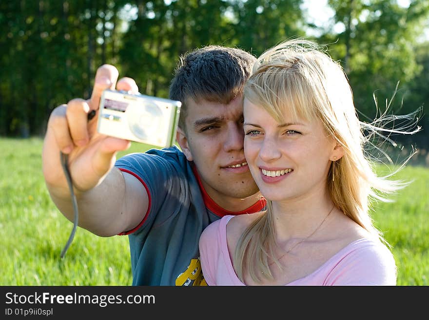 Happiness couple in love with digital camera smiling. Happiness couple in love with digital camera smiling