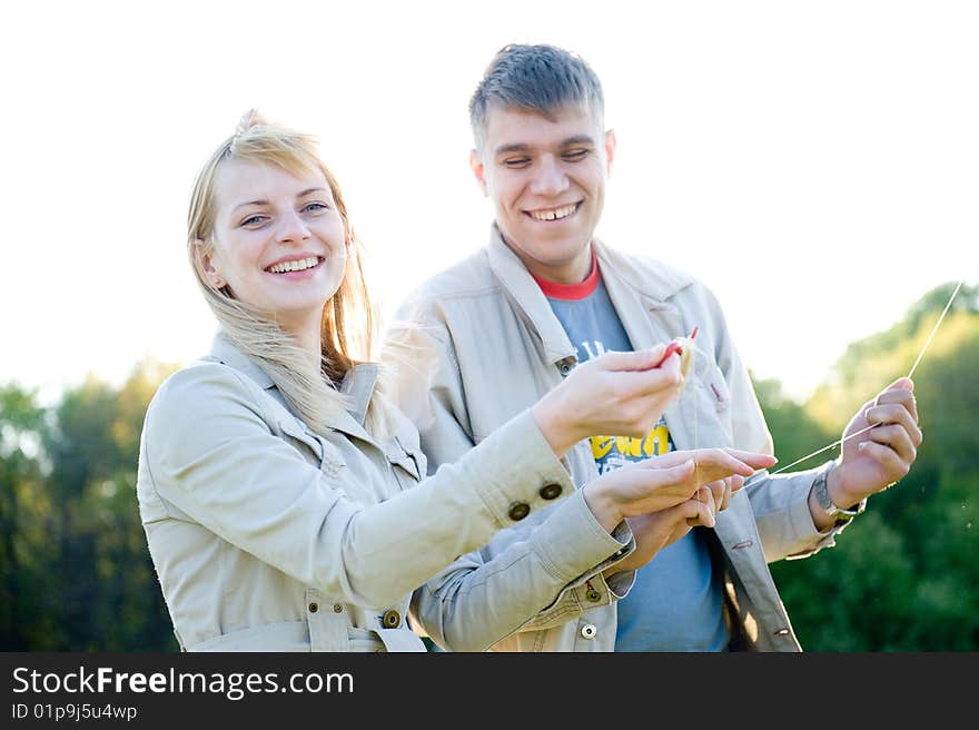 Happy young couple in love flying a kite