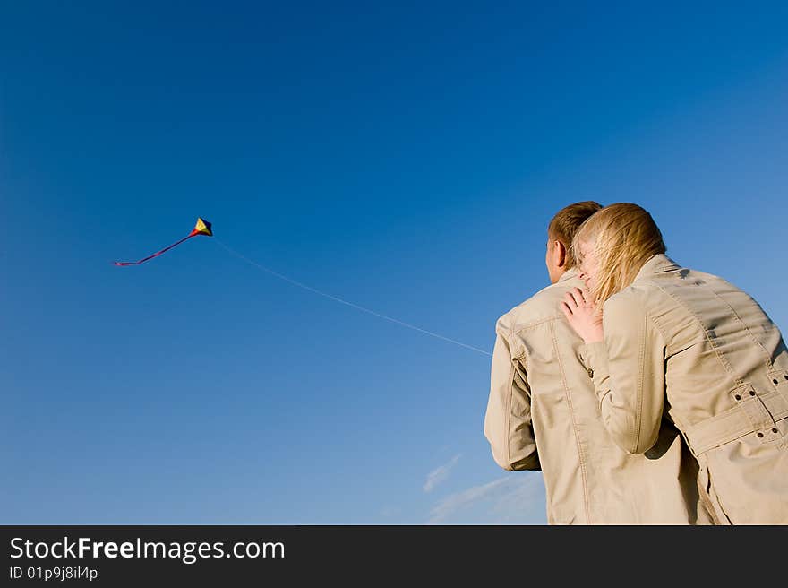 Happy young couple in love flying a kite