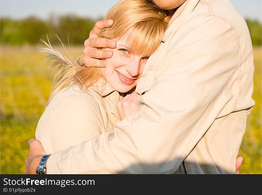 The loving couple embraces. Close-up portrait of smiling girl in love