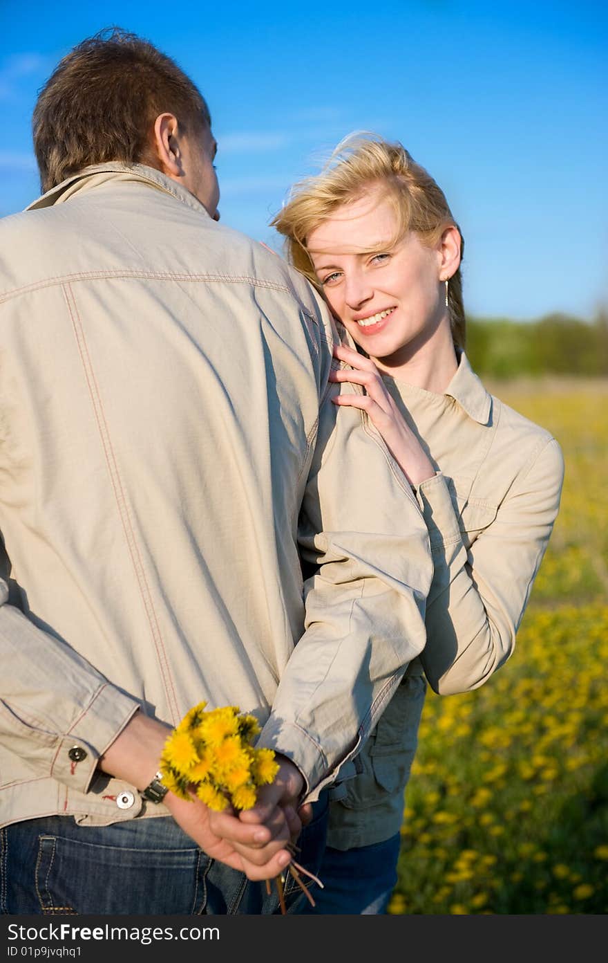 Bouquet of dandelions for the favourite. Young couple in love