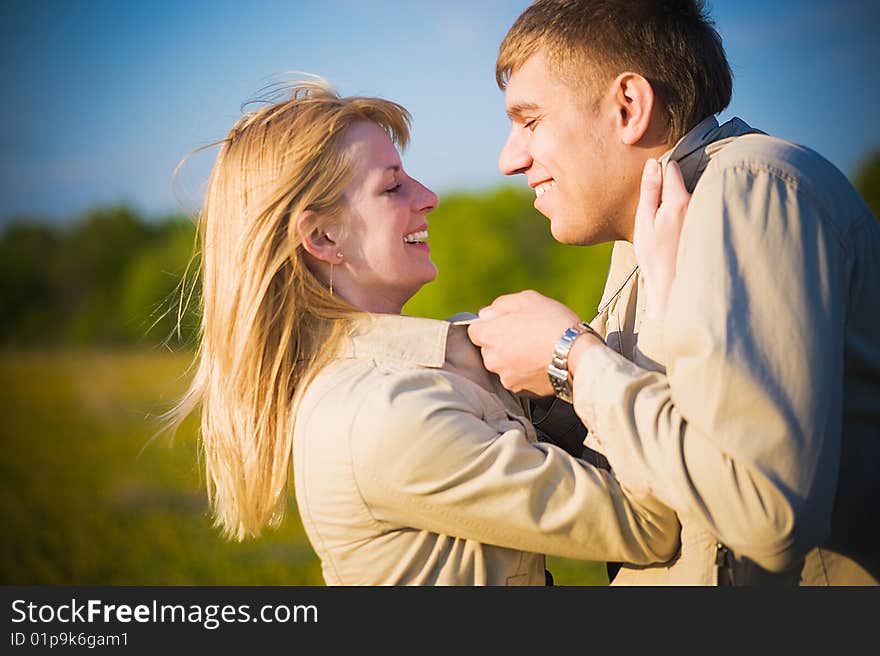 Couple in love across the field, embrace and kiss