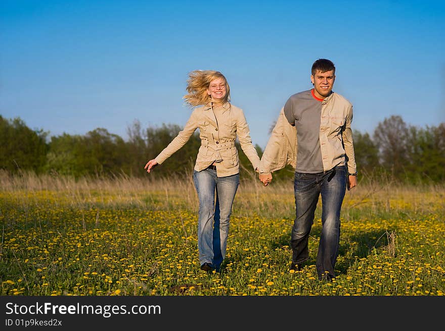 Happy couple walk across the field. Happy couple walk across the field