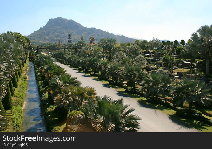 Road and channel leaving in distance in palm path to temple and grief