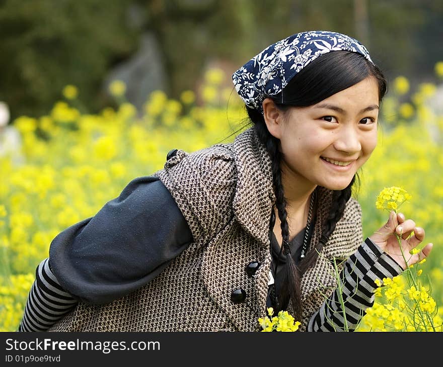 and beautiful young happy woman. In the yellow flower background. and beautiful young happy woman. In the yellow flower background