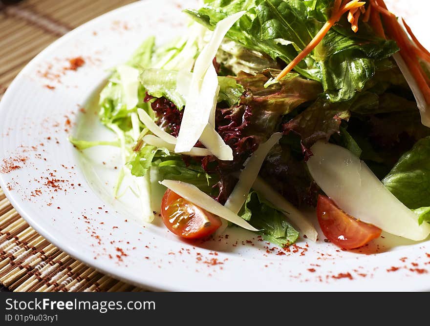 White plate of salad on the table