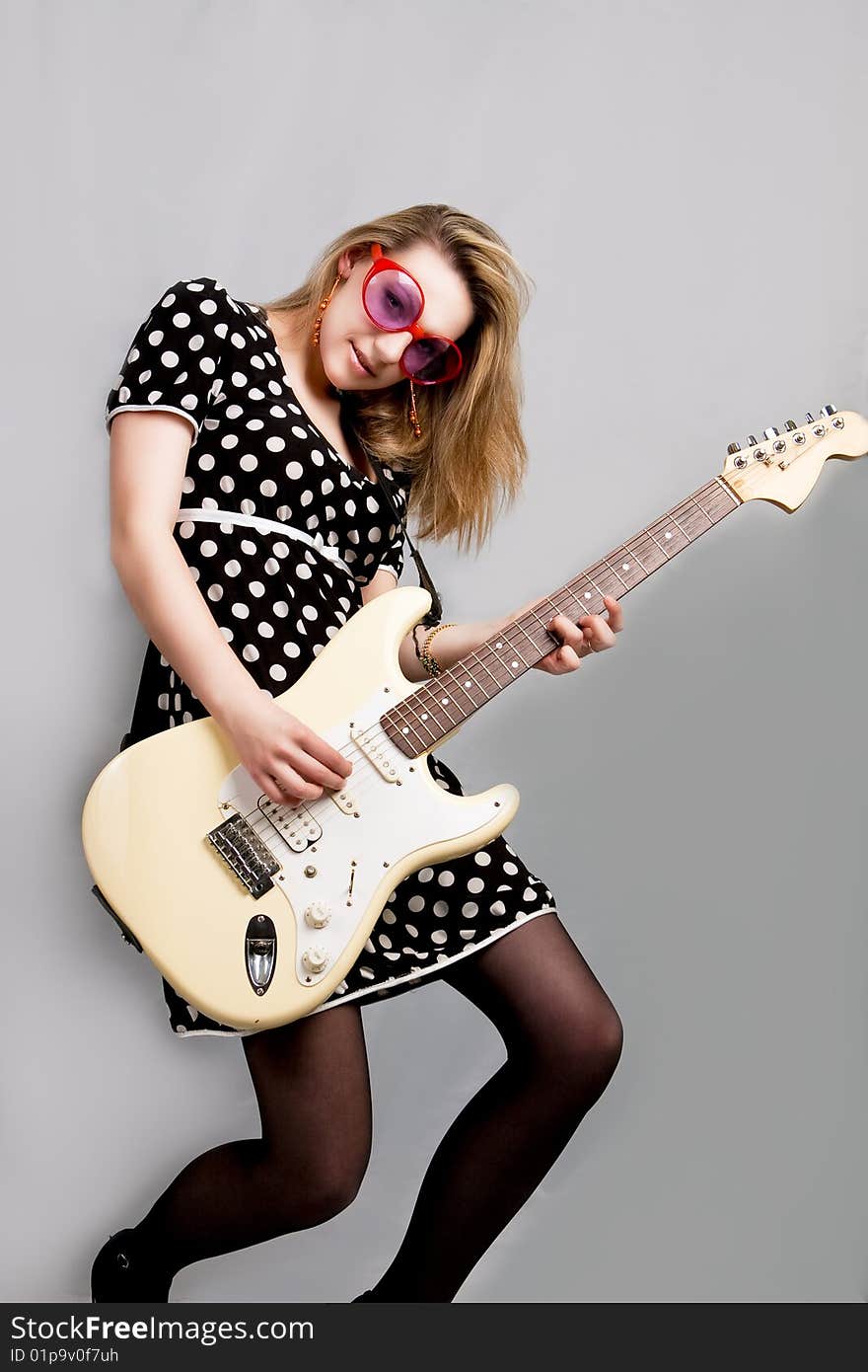 Young girl playing guitar isolated