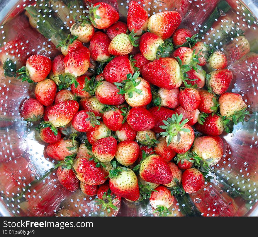 Strawberries after washing in strainer. Strawberries after washing in strainer