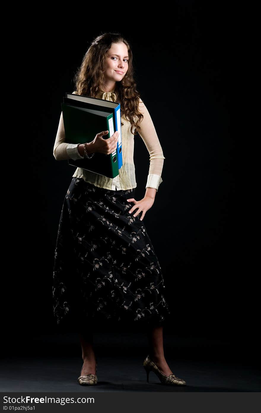 Photo of the woman with folders on a black background. Photo of the woman with folders on a black background