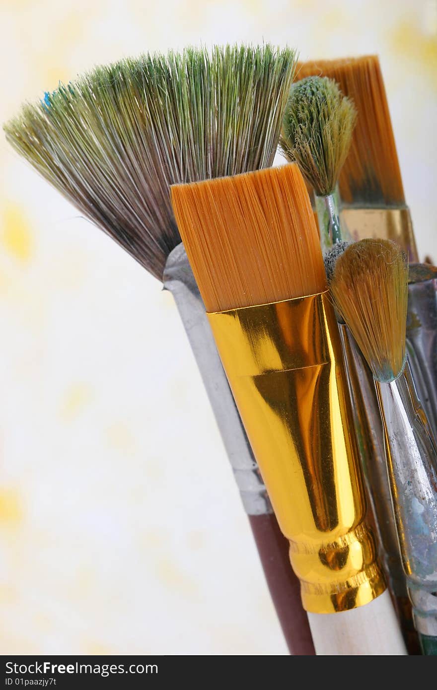 Old paintbrushes on painted background.