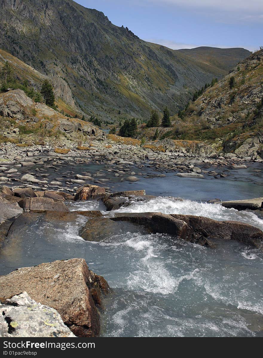 Stream of the river among large stones, high rocks, the mountains, separate cedars. Stream of the river among large stones, high rocks, the mountains, separate cedars.