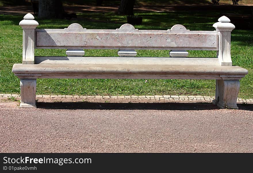 Carved stone park bench in garden. Carved stone park bench in garden