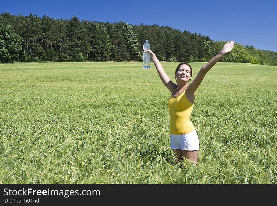 A beautiful woman feels happy on the field. A beautiful woman feels happy on the field.