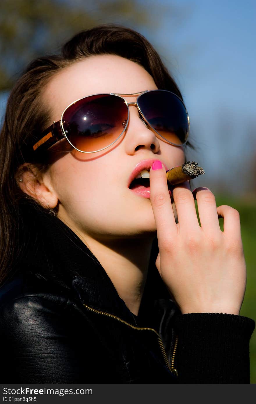 The girl smoking a cigar