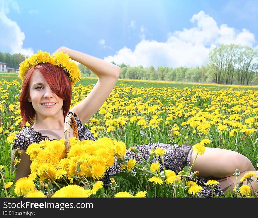 Beautiful redhead girl with dandelions. Beautiful redhead girl with dandelions