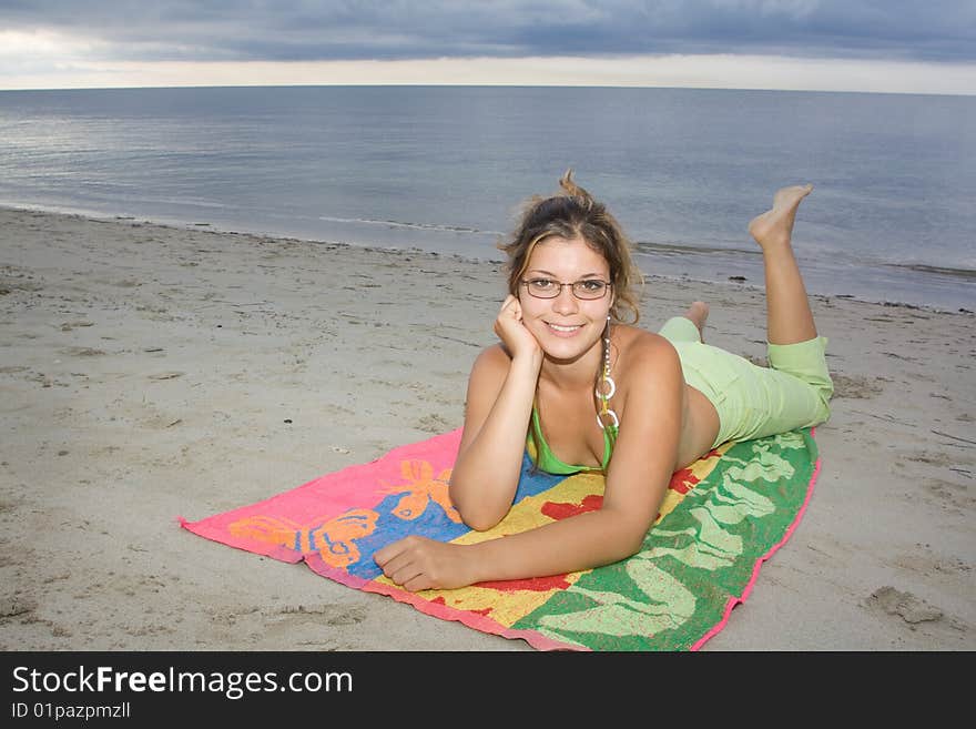 Beautiful Lady Smiling, Laying On A Towel (I)