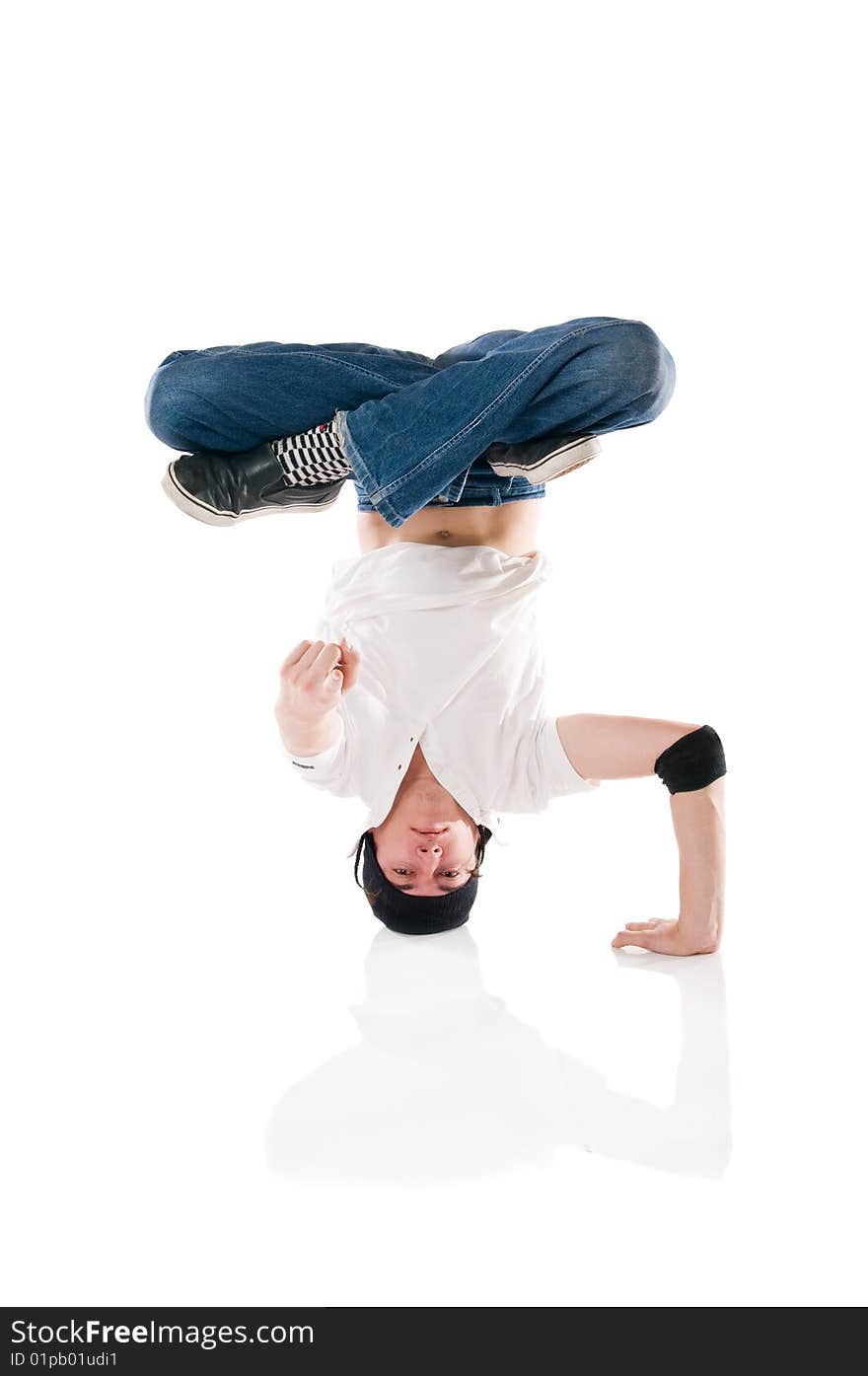 Young happy breakdancer posing upside down and pointing the index finger at you!. Young happy breakdancer posing upside down and pointing the index finger at you!