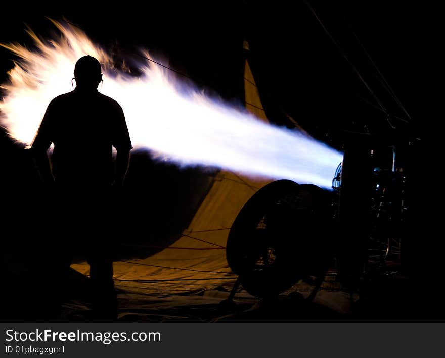 Man Standing Next to Hot Air Balloon Exhuast Burner. Man Standing Next to Hot Air Balloon Exhuast Burner