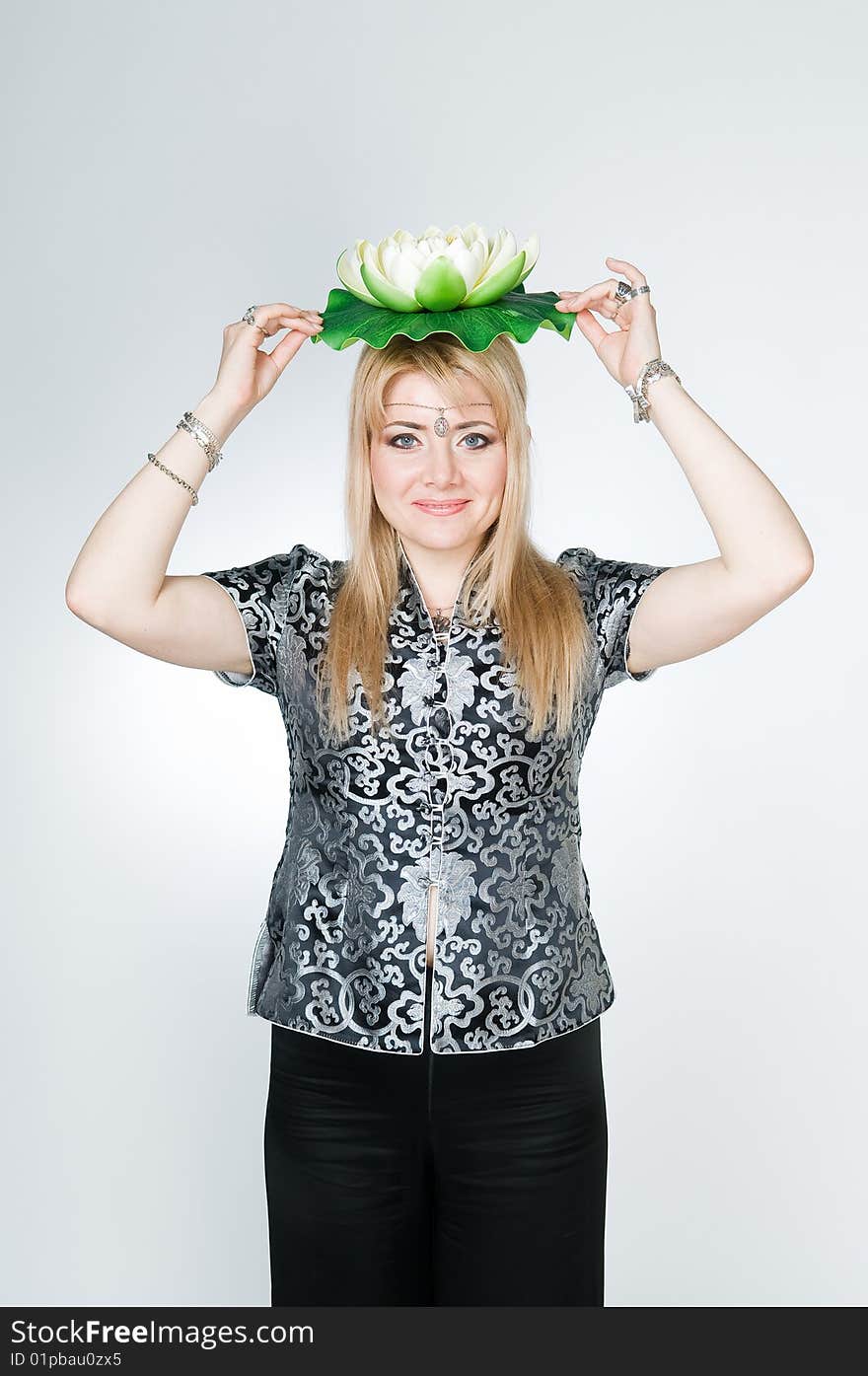 Beautiful woman with lotus flower, studio shot