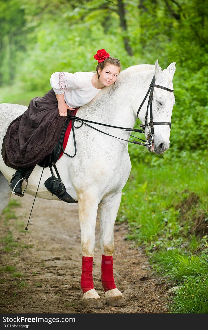 Beautiful girl with horse in the forest