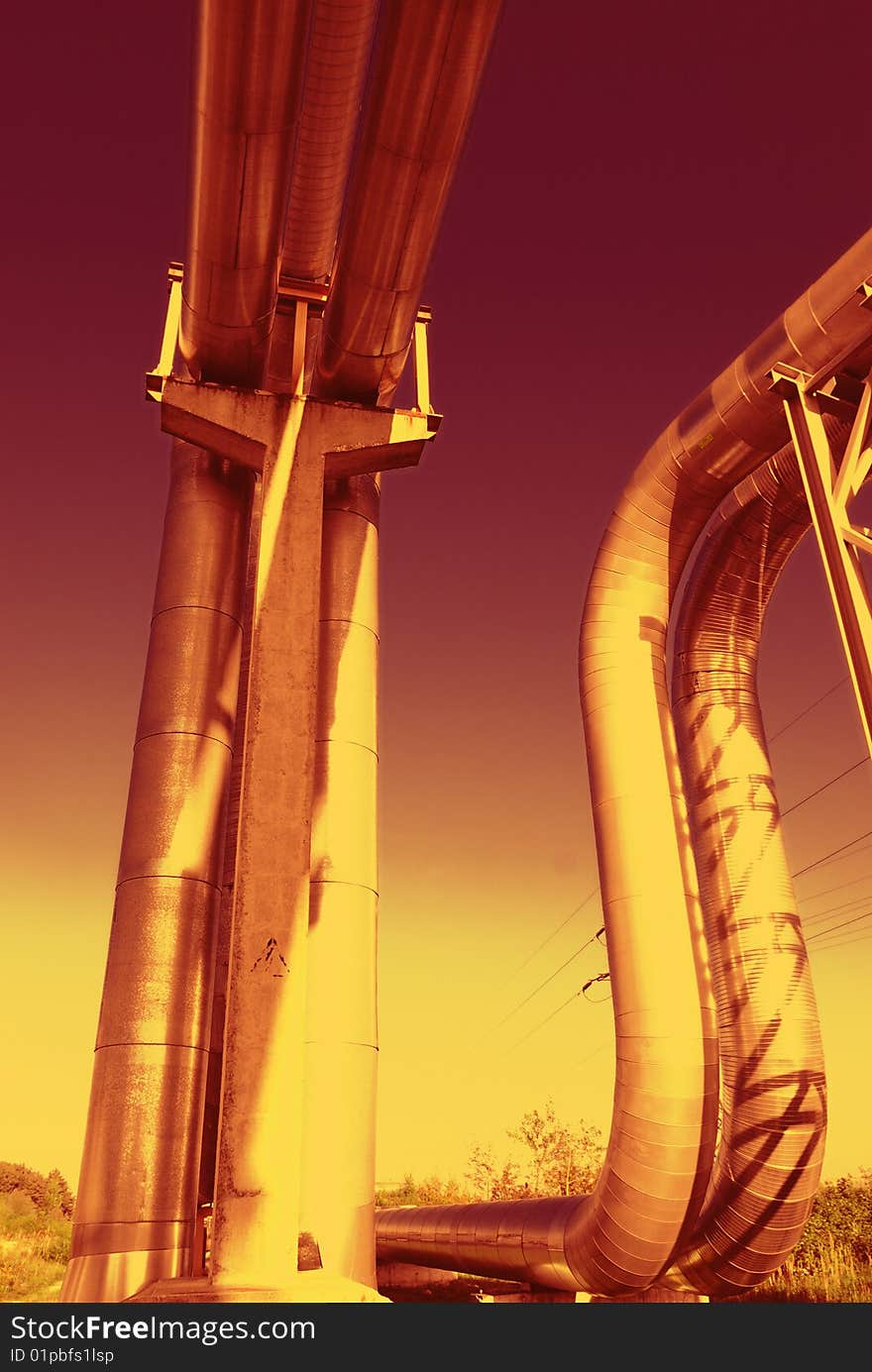 Industrial pipelines on pipe-bridge against blue sky. Industrial pipelines on pipe-bridge against blue sky.