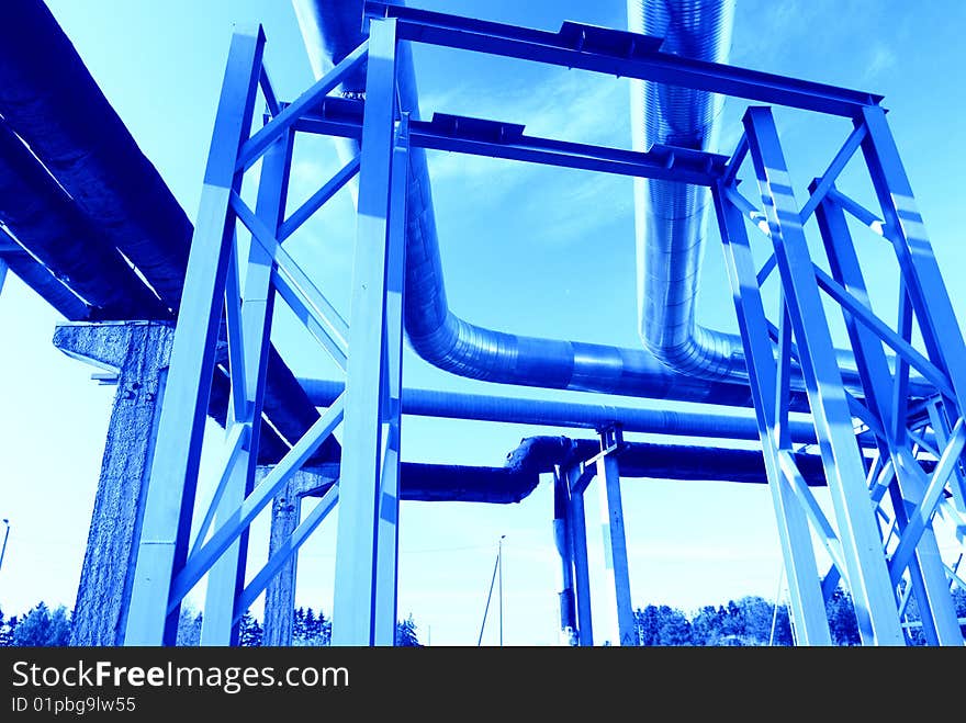 Industrial pipelines on pipe-bridge against blue sky. Industrial pipelines on pipe-bridge against blue sky.