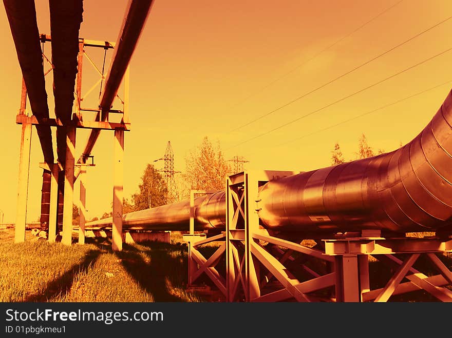 Industrial pipelines on pipe-bridge against blue sky. Industrial pipelines on pipe-bridge against blue sky.