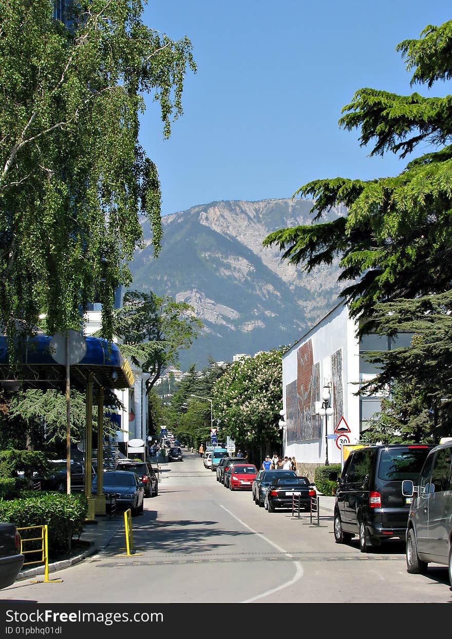 Street of city on a background mountains and dark blue sky in Crimea. Street of city on a background mountains and dark blue sky in Crimea.