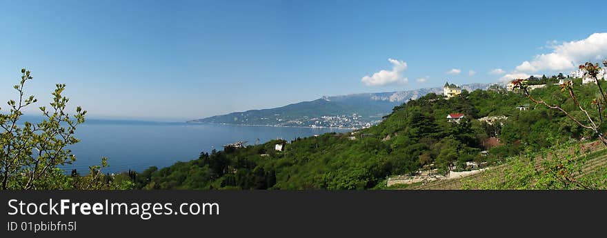 Mountain and marine landscape on a background blue sky. Mountain and marine landscape on a background blue sky