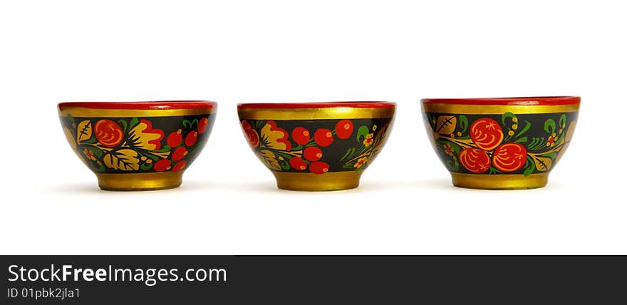 Three painted Russian khokhloma wooden cups isolated. Three painted Russian khokhloma wooden cups isolated