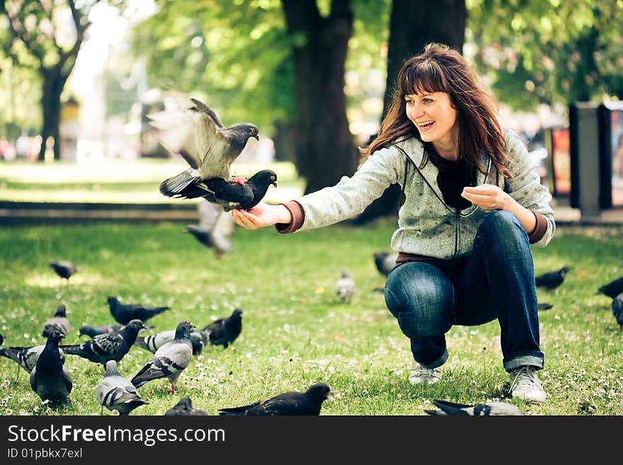 Happy woman with doves in the park