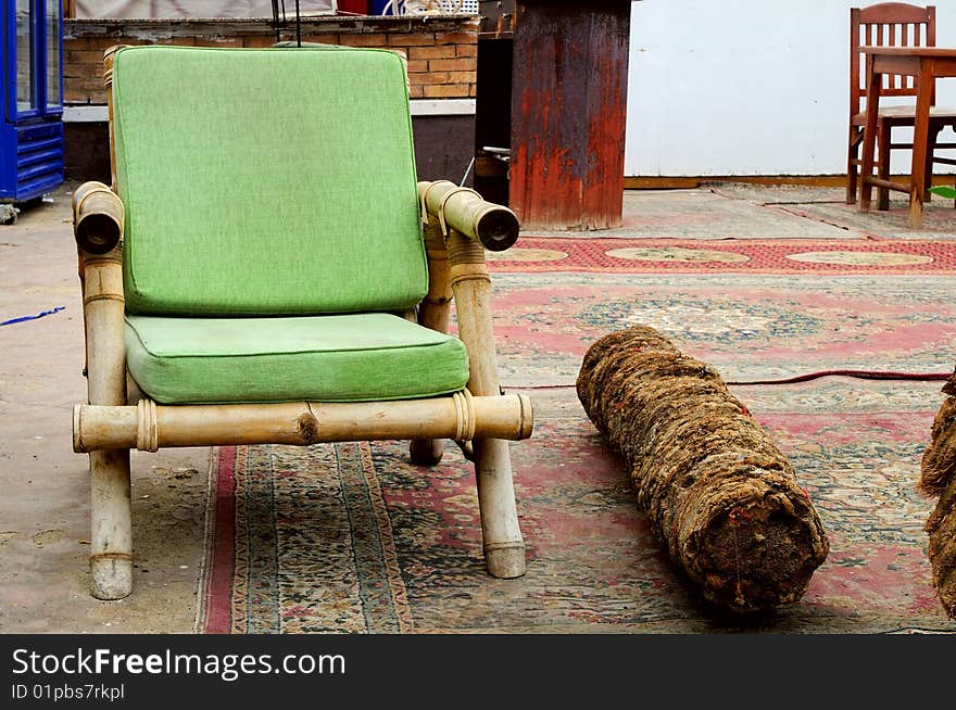 Old Green African armchair in exotic street cafe