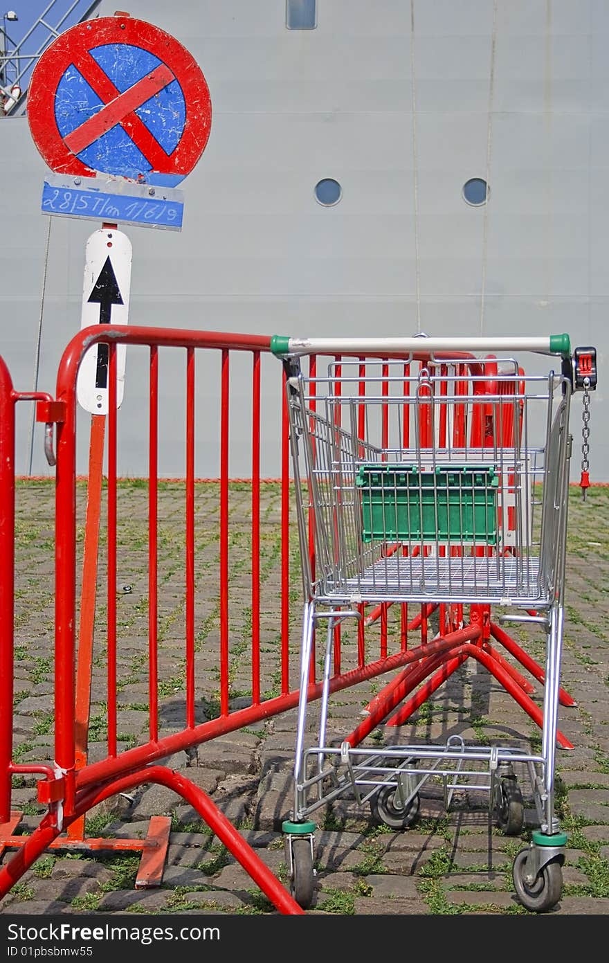 No parking sign with a parked (abandoned) and empty shopping cart :-)