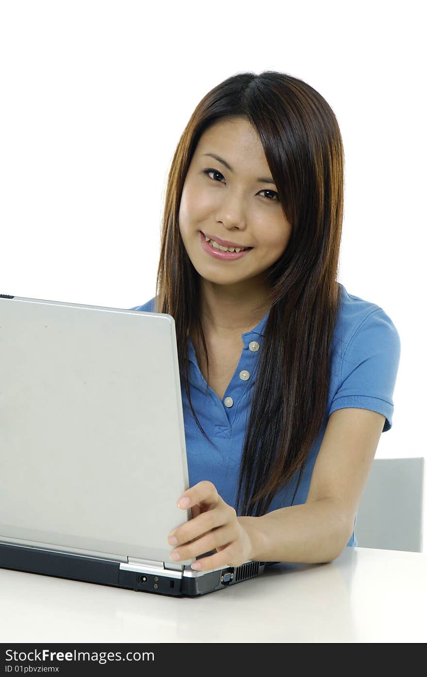 A pretty asian woman working on the laptop. A pretty asian woman working on the laptop