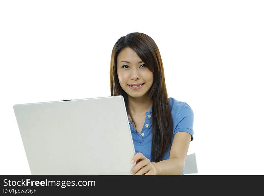 A pretty asian woman working on the laptop. A pretty asian woman working on the laptop