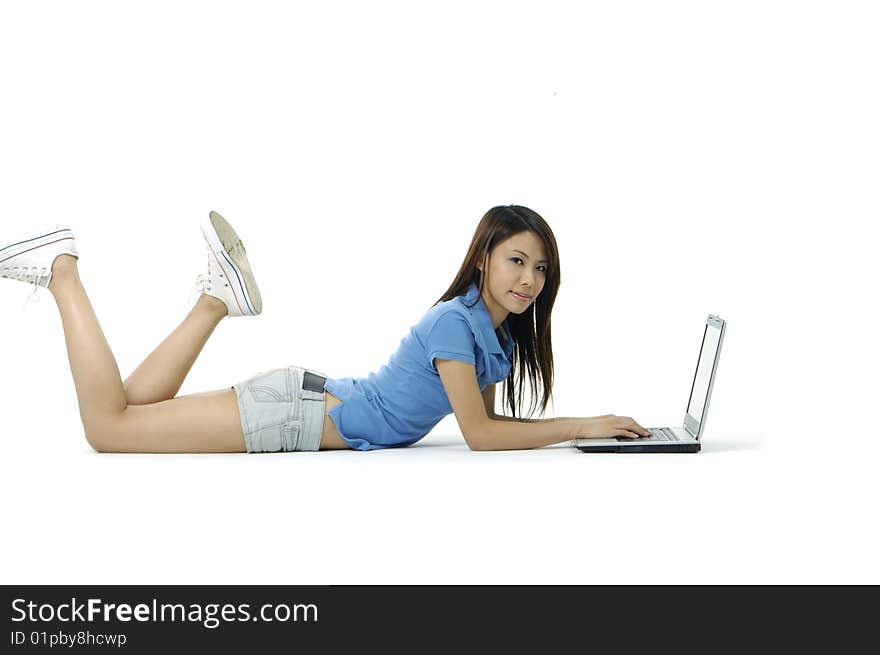 Beautiful asian women of a leggy girl laying flat on bed typing on her laptop pc. Beautiful asian women of a leggy girl laying flat on bed typing on her laptop pc