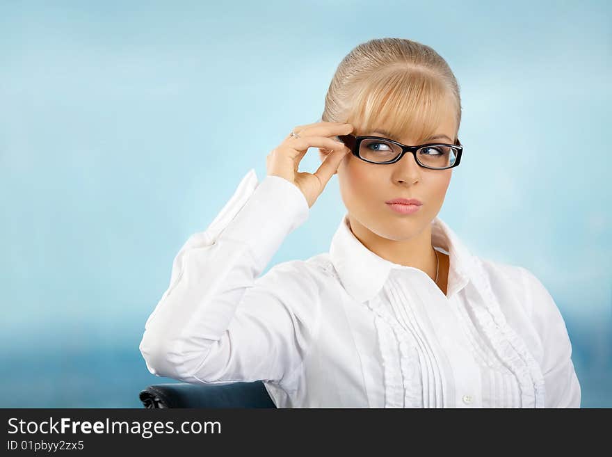 Beautiful businesswoman touches the glasses at office