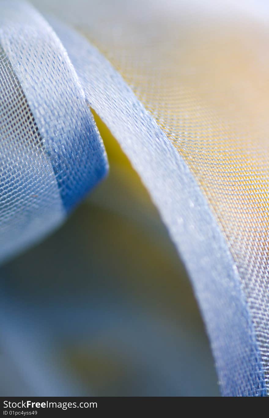 Macro of a curled blue ribbon