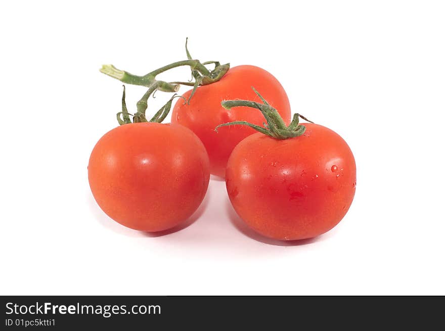 A small group of cherry tomatoes isolated against a white background