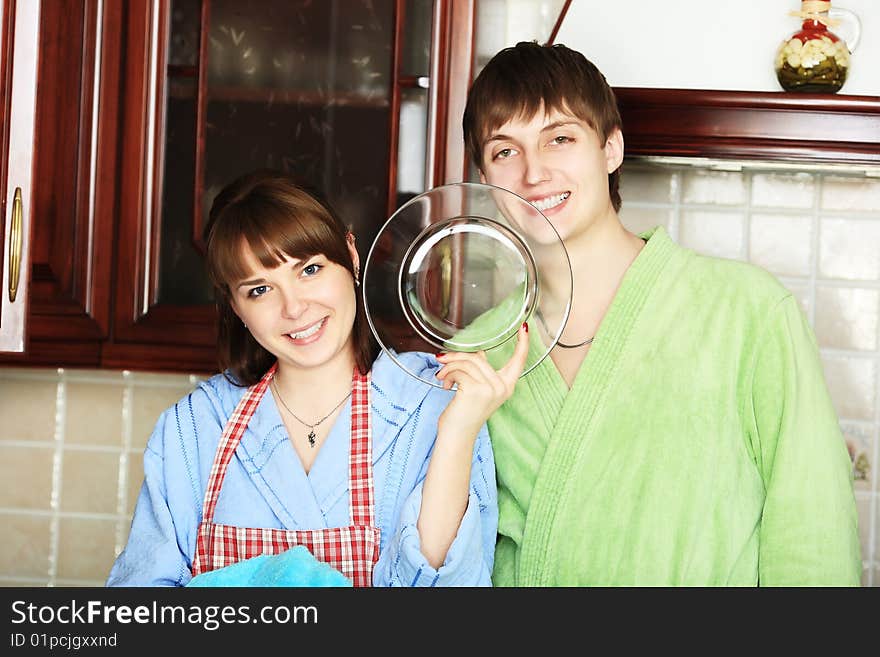 Happy young couple on a kitchen at home. Happy young couple on a kitchen at home.