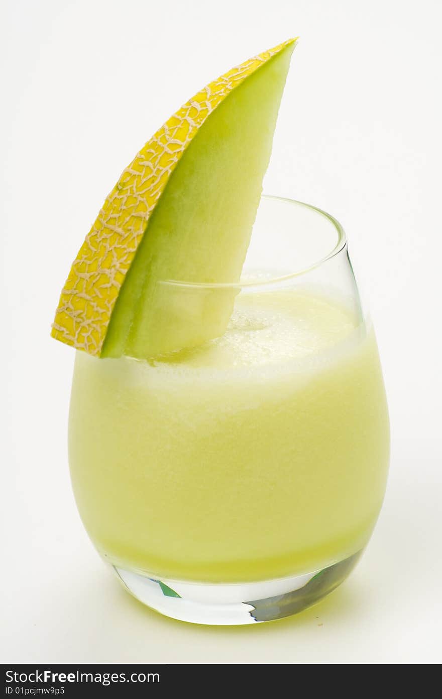 A delicious melon milkshake isolated over white. A delicious melon milkshake isolated over white