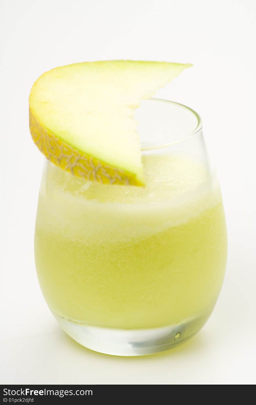 A delicious melon milkshake isolated over white. A delicious melon milkshake isolated over white